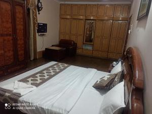 a bedroom with a bed and a chair in a room at The Candy Suites in Rānchī