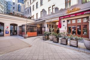 an empty street in a city with buildings at BpR City Lodge Apartments in Budapest