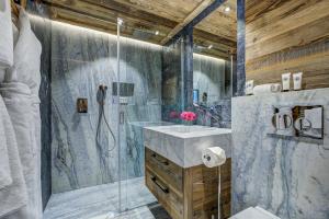 a bathroom with a shower and a sink at Le Hameau des Nants in Chamonix-Mont-Blanc +44 photos