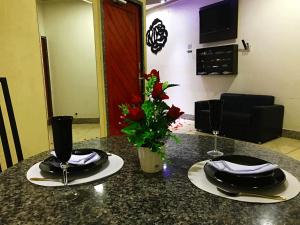 a table with two place settings on top of it at Motel Emoções (Adults Only) in Fortaleza