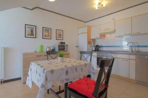 a kitchen with a table with a white table cloth at FeWo Leuchtturm Wremen in Wremen