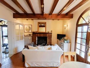 a living room with a white couch and a fireplace at Casa Nives in San Pietro in Casale