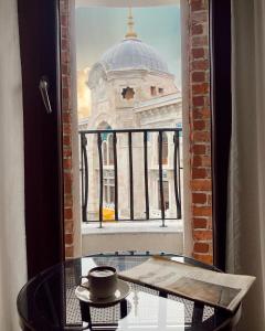 a glass table in front of a window with a building at Grand Sirkeci Hotel in Istanbul