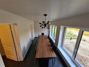 a long dining room with a long table and windows at Sonda puhkemaja in Sonda