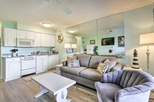 a living room with a couch and a table at Coastal Condo with Balcony and Luxe Resort Amenities! in Hilton Head Island