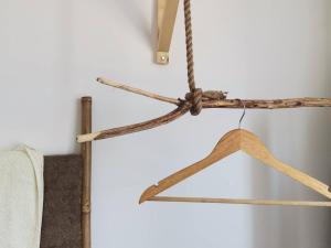 a wooden hanger hanging on a wall at LC-House in Ponta Delgada