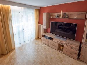 a living room with a large flat screen tv at Ferienwohnungen Bergsonne und Gipfelsonne in Bad Reichenhall