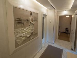 a painting of a dress on a wall in a hallway at Ferienwohnungen Bergsonne und Gipfelsonne in Bad Reichenhall +40 photos