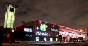 un edificio con luces de Navidad encendidas por la noche en Hotel Boutique Mendoza - Cerca Aeropuerto El Dorado, en Bogotá