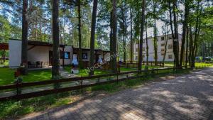 a house with a fence next to a road at Villa Kama in Skorzęcin