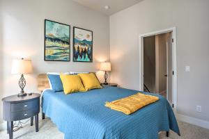 a bedroom with a blue bed and two lamps at Trendy Denver Townhome - Walk to Mile High Stadium in Denver