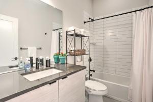 a bathroom with a sink and a toilet and a shower at Trendy Denver Townhome - Walk to Mile High Stadium in Denver +17 photos
