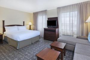 a hotel room with two beds and a television at Staybridge Suites Lansing-Okemos, an IHG Hotel in Okemos