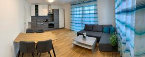 a living room with a couch and a table at Modern airconditioned city apartment close to VIC in Vienna