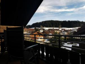 a balcony with a view of a town with snow at Ferienwohnung Stillleben in Ofterschwang