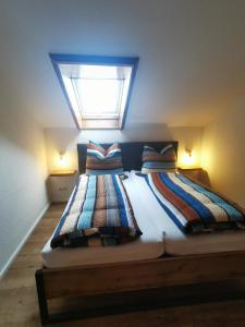 a bedroom with two beds with a skylight at Ferienwohnung Stillleben in Ofterschwang