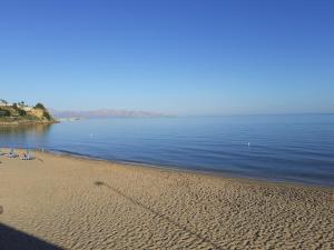a beach with chairs and the ocean on a sunny day at LA FINESTRA SUL MARE PIANO Terra in Trappeto