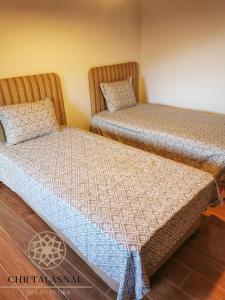 two beds sitting next to each other in a room at CHR Talasnal_Casa da Pedra in Lousã