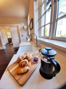 a cutting board with pastries on a kitchen counter at The Garden Cottage of Warren Lodge boutique cottages in Dromod