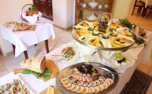 bufet z wieloma różnymi rodzajami żywności na stole w obiekcie Villa Stella Maris w mieście Międzyzdroje