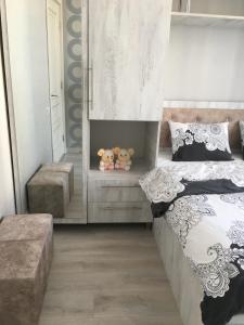 a bedroom with a bed and two stuffed animals on a shelf at Сдается уютная двухкомнатная квартира с джакузи в Батуми in Batumi +15 photos