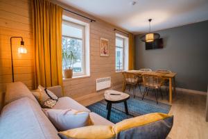 a living room with a couch and a table at Mere 38 Apartments in Võsu