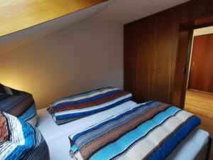 a bedroom with two beds with striped blankets at Ferienwohnung Stillleben in Ofterschwang