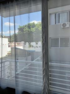 a view of a balcony from a window at Departamento a cuadras del hospital Italiano in Buenos Aires