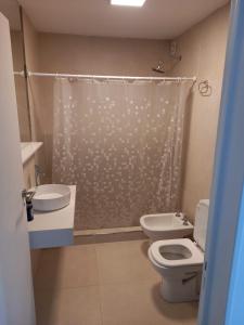 a bathroom with a toilet and a shower curtain at Departamento a cuadras del hospital Italiano in Buenos Aires