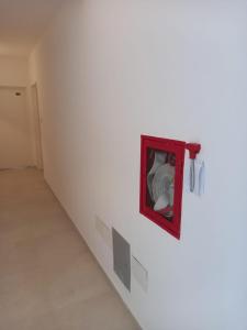 a white room with a red frame on a wall at Departamento a cuadras del hospital Italiano in Buenos Aires