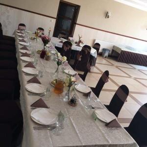 a long table with plates and napkins on it at Villa Kama in Skorzęcin