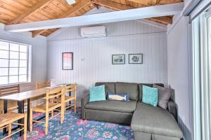 a living room with a couch and a table at Charming Jacuzzi-Suite - Walk to Parsons Beach! in Kennebunk