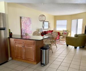 a living room with a kitchen and a living room with a couch at Vistas on the Gulf by Liberte' in St Pete Beach