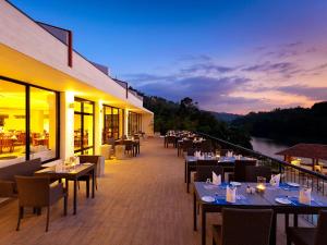 a restaurant with tables, chairs and tables at Cinnamon Citadel Kandy in Kandy