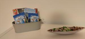 a bowl of books and a bowl of food on a table at Casa Blouberg in Gordevio