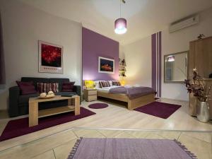 A bed or beds in a room at ABT Apartments Karoly