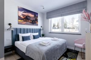 a bedroom with a bed with two towels on it at Śnieżka Exclusive Apartamenty in Kowary