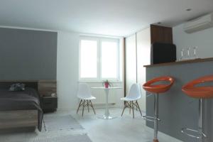 a bedroom with a bed and a table and chairs at Apartmán - Dlhé Diely in Bratislava