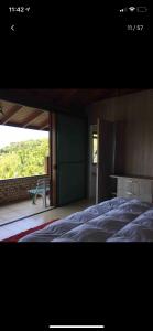 a bedroom with a large bed and a balcony at Aloha spa in Florianópolis +89 photos