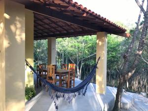 a hammock on the porch of a house at Espaço Terra Dourada, Ibicoara, Chap Diamantina in Ibicoara