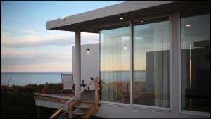 Cette maison dispose d'un balcon avec vue sur l'océan. dans l'établissement Médanos Patagonia, à Las Grutas