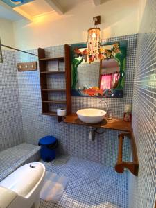 a bathroom with a sink and a mirror at AmimodoBeachRooms in Puerto Viejo +39 photos