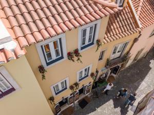 an overhead view of a building with people walking on the street at Castle Inn Lisbon Apartments in Lisbon