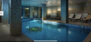 a large swimming pool in a building with a pool at Апартамент в комплекс Смолянски езера in Smolyan