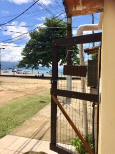a gate to a building with a view of the ocean at Suíte da Vila - Beira Mar in Abraão