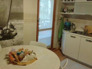 a kitchen with a table with a bowl of food on it at Su Planu in Cagliari