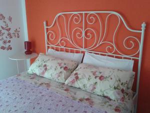 a bed with a metal head board and pillows at Su Planu in Cagliari