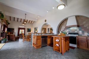 a large kitchen with a counter and a dining room at El Gran Castillo De Arena - 4 Bedroom in San Pedro