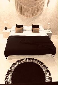 Apartments & Suites MADRE Holbox Self-Check IN客房内的一张或多张床位