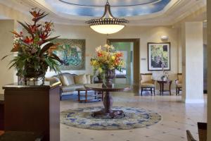a lobby with a table with flowers on it at Holiday Inn Club Vacations Sunset Cove Resort in Marco Island